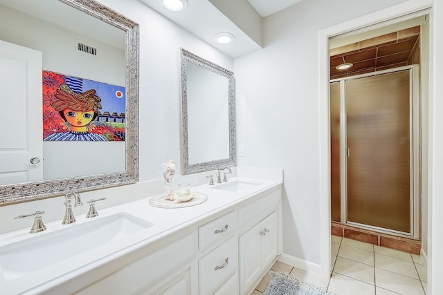 bathroom featuring tile patterned flooring, vanity, and walk in shower