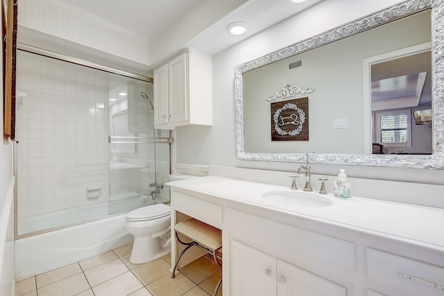 full bathroom with tile patterned floors, vanity, combined bath / shower with glass door, and toilet