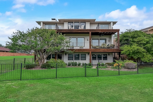 rear view of property featuring a lawn and a balcony