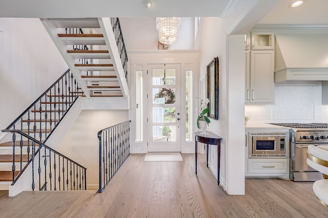 435 Columbia Dr, Rockwall, TX 75032 - living area with a premium fireplace, crown molding, plenty of natural light, and light wood finished floors