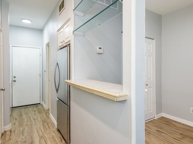 hall with light hardwood / wood-style floors