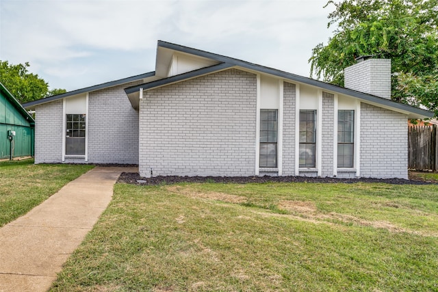 view of side of home featuring a yard