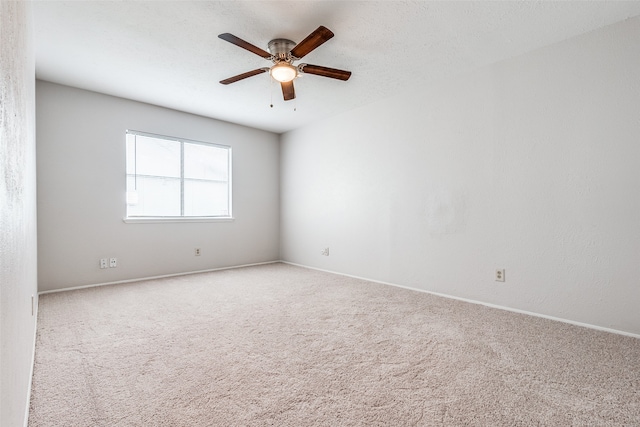 unfurnished room featuring carpet, ceiling fan, and a textured ceiling