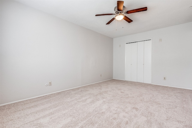 unfurnished bedroom with ceiling fan, carpet floors, and a closet