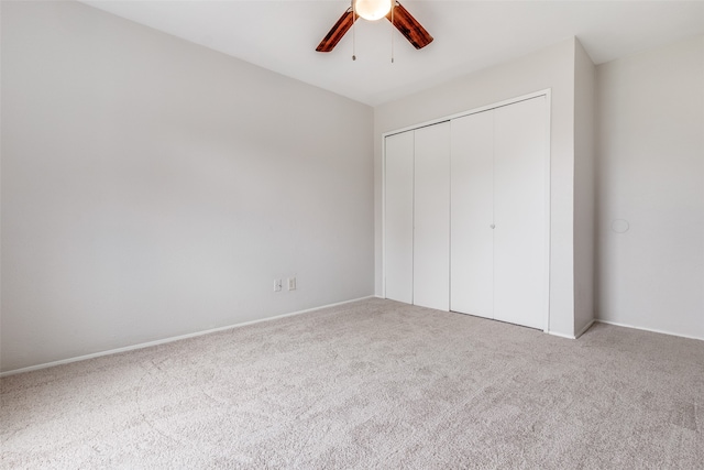 unfurnished bedroom with carpet, ceiling fan, and a closet