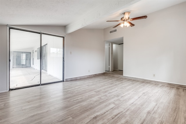 spare room featuring vaulted ceiling with beams, a textured ceiling, light hardwood / wood-style floors, and ceiling fan