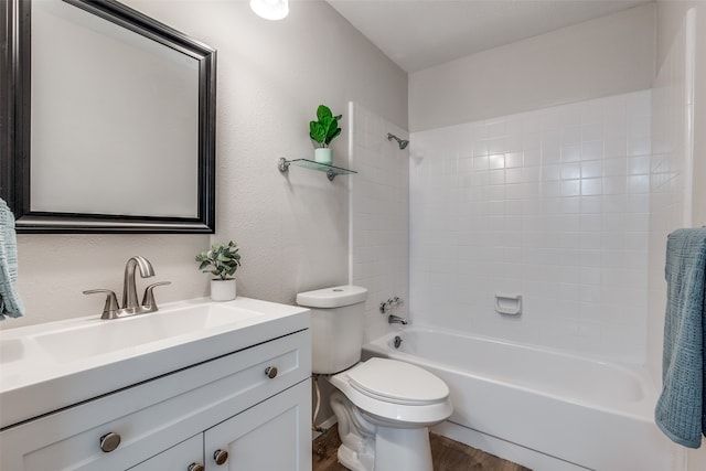 full bathroom featuring tiled shower / bath, toilet, vanity, and hardwood / wood-style flooring