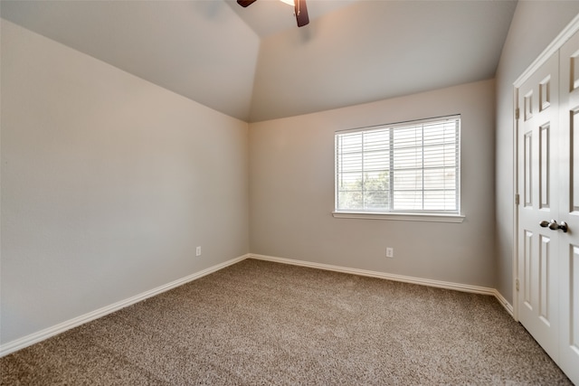 unfurnished bedroom with carpet flooring, ceiling fan, and vaulted ceiling