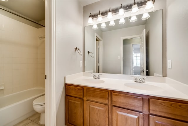 full bathroom featuring toilet, vanity, tile patterned floors, and tiled shower / bath