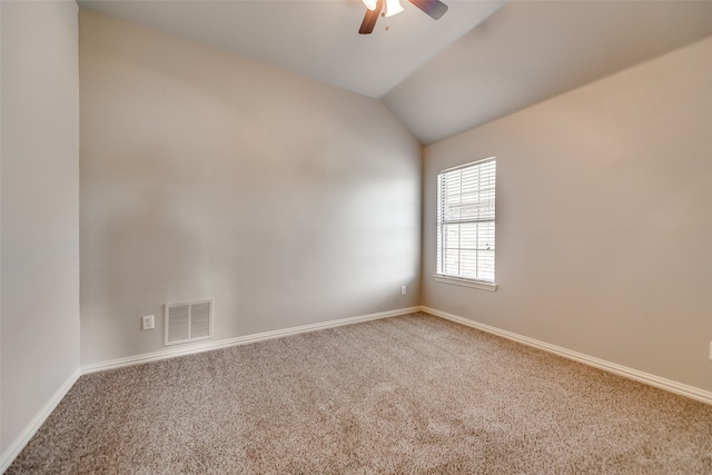 carpeted empty room with ceiling fan and lofted ceiling