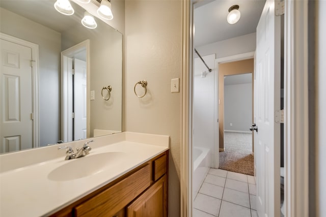 bathroom featuring tile patterned flooring, vanity, and tub / shower combination