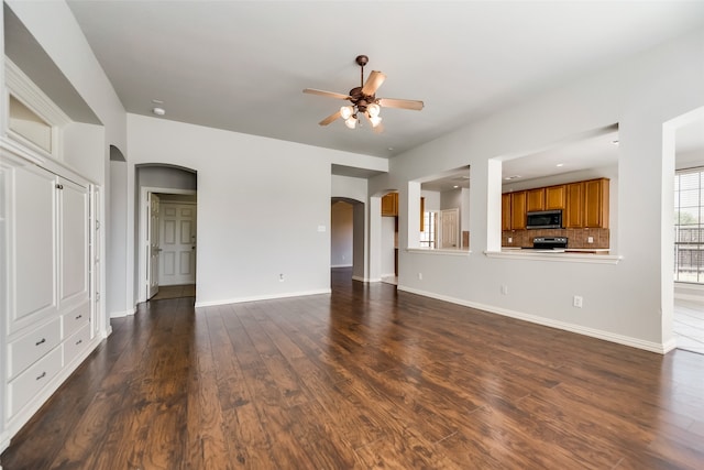 unfurnished living room with ceiling fan and dark hardwood / wood-style flooring