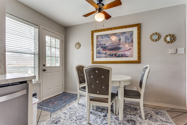 tiled dining room featuring ceiling fan