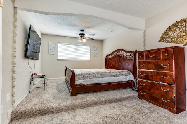 carpeted bedroom with a textured ceiling and ceiling fan