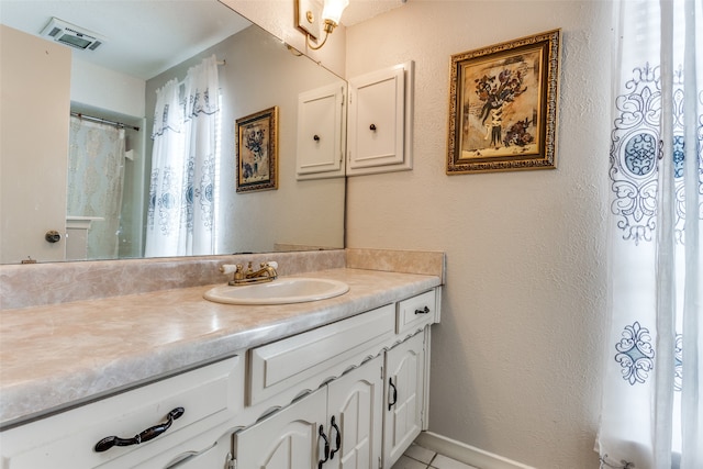 bathroom featuring tile patterned floors and vanity