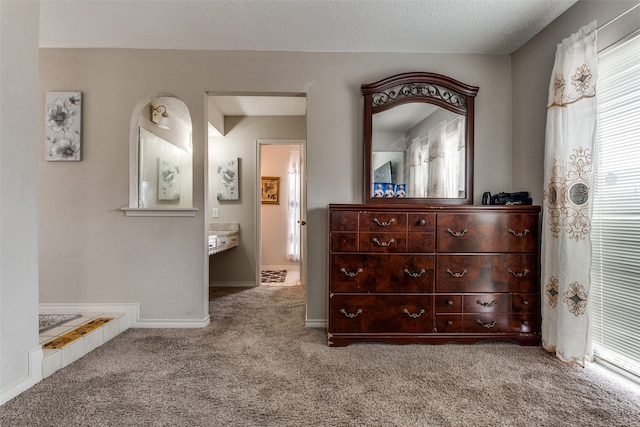 carpeted bedroom with a textured ceiling