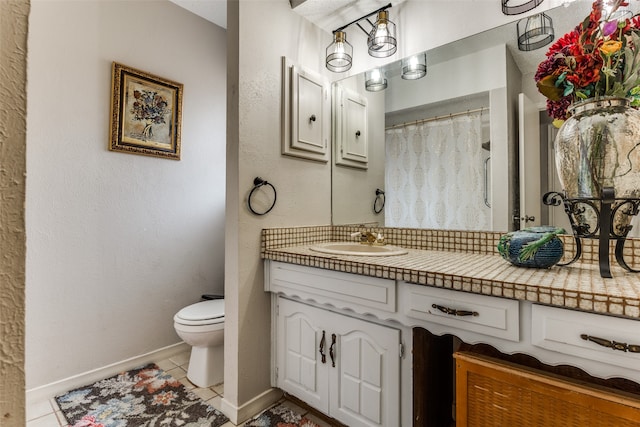 bathroom with tile patterned floors, vanity, and toilet