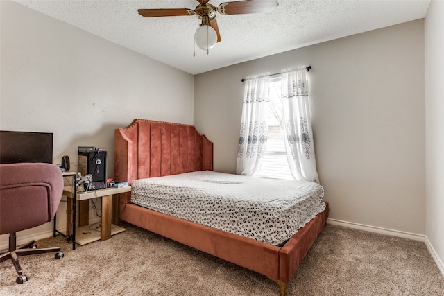 carpeted bedroom featuring a textured ceiling and ceiling fan