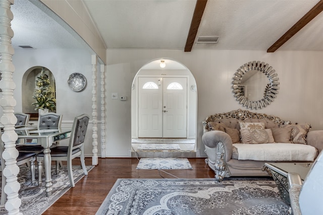 entryway with lofted ceiling with beams, dark hardwood / wood-style flooring, and a textured ceiling