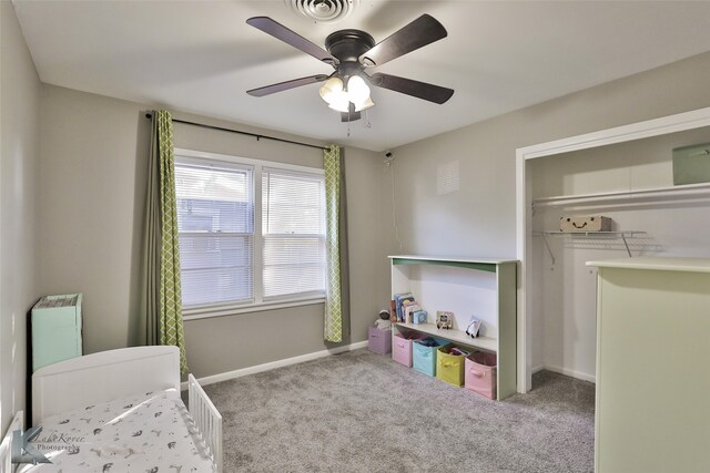 bedroom featuring a closet, light colored carpet, and ceiling fan