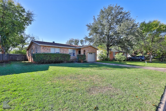 ranch-style house featuring a garage and a front yard