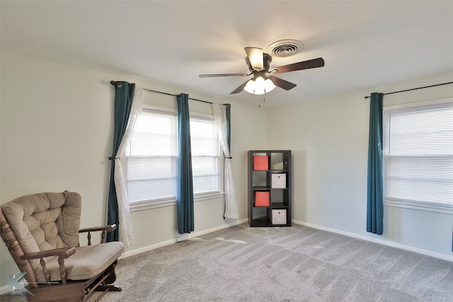 sitting room featuring ceiling fan and light colored carpet