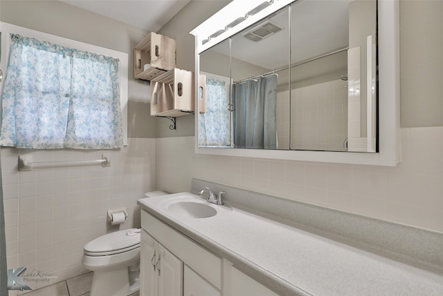 bathroom featuring tile patterned flooring, toilet, vanity, tile walls, and a shower with shower curtain