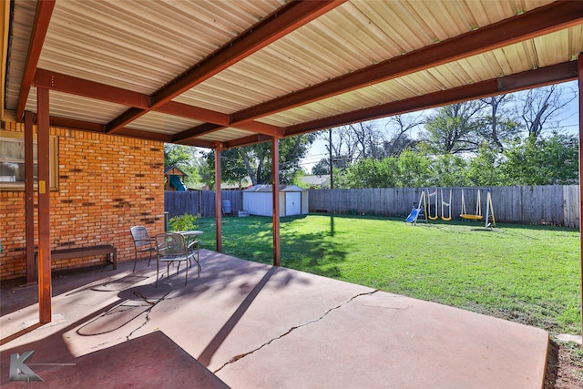 view of patio / terrace with a playground and a shed