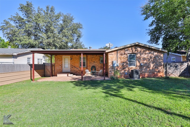 back of property featuring a lawn and a patio area