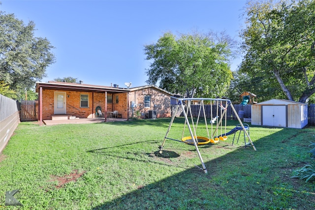 view of yard featuring a playground, a shed, a patio, and central AC unit