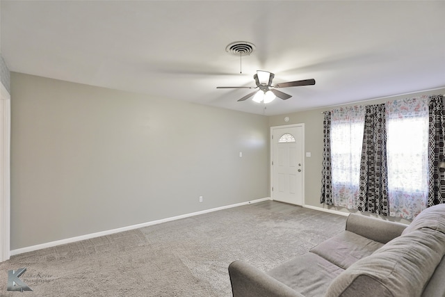 carpeted living room with ceiling fan