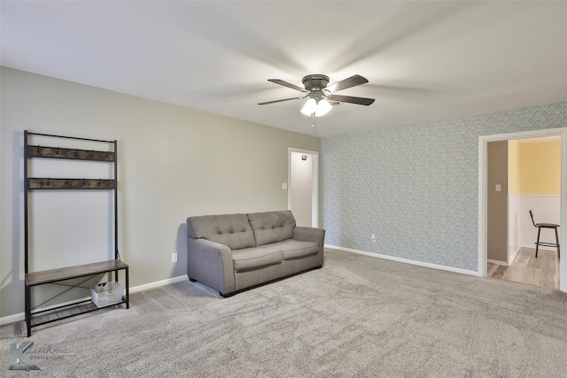 living area with ceiling fan and light carpet