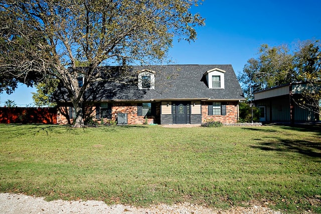 new england style home featuring a front yard