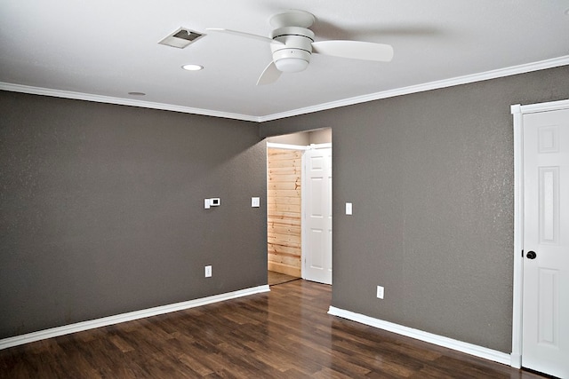 spare room featuring dark hardwood / wood-style flooring, ceiling fan, and ornamental molding