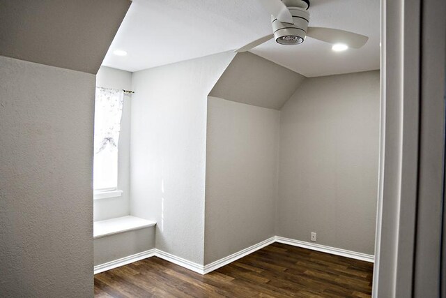 additional living space with ceiling fan, lofted ceiling, and dark wood-type flooring