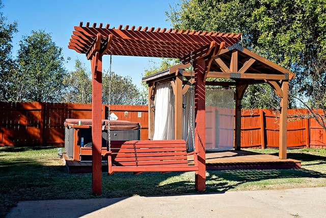 exterior space featuring a pergola, a yard, and a hot tub