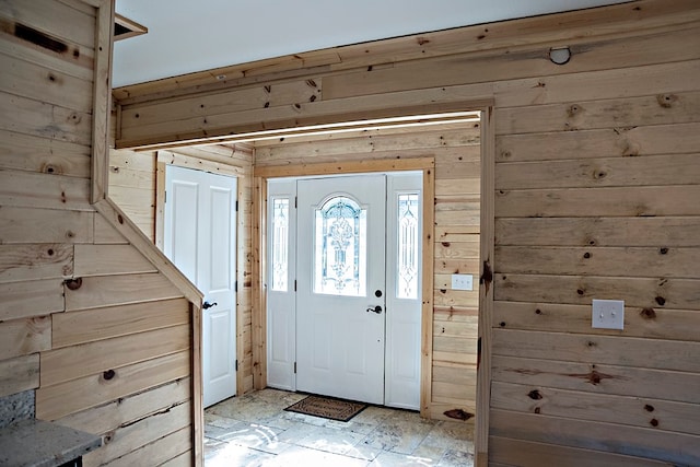 entryway featuring wood walls