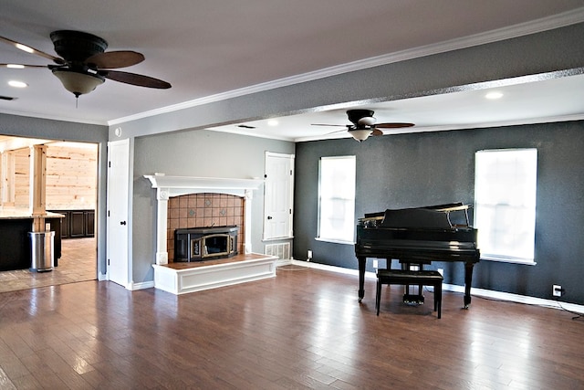 living room with crown molding, ceiling fan, and wood-type flooring