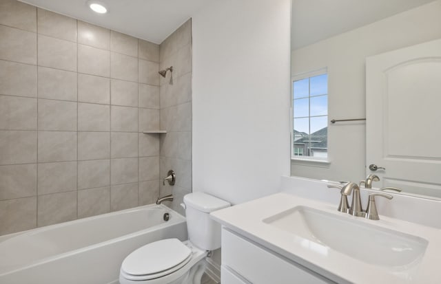 full bathroom featuring toilet, vanity, and tiled shower / bath