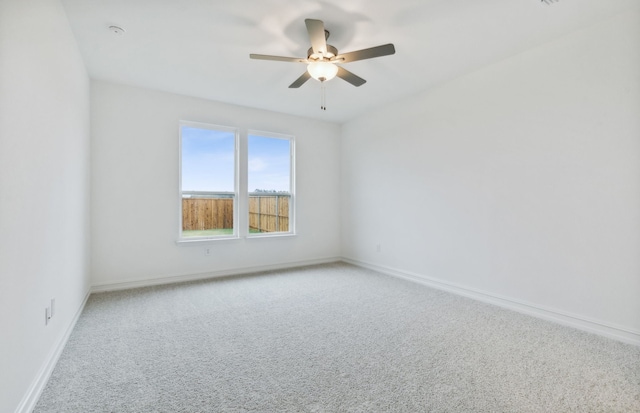 spare room with carpet floors and ceiling fan