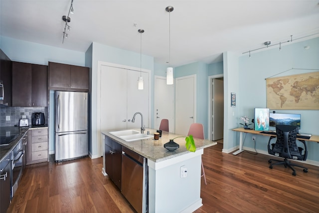 kitchen featuring a kitchen island with sink, sink, dark hardwood / wood-style floors, dark brown cabinetry, and stainless steel appliances