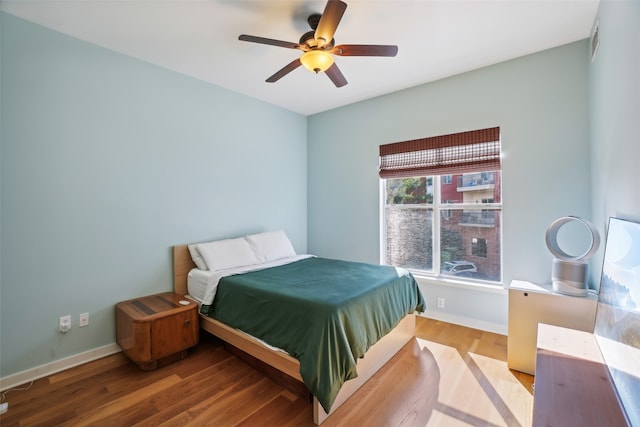 bedroom with wood-type flooring and ceiling fan