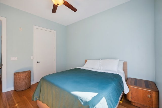 bedroom with ceiling fan and hardwood / wood-style flooring