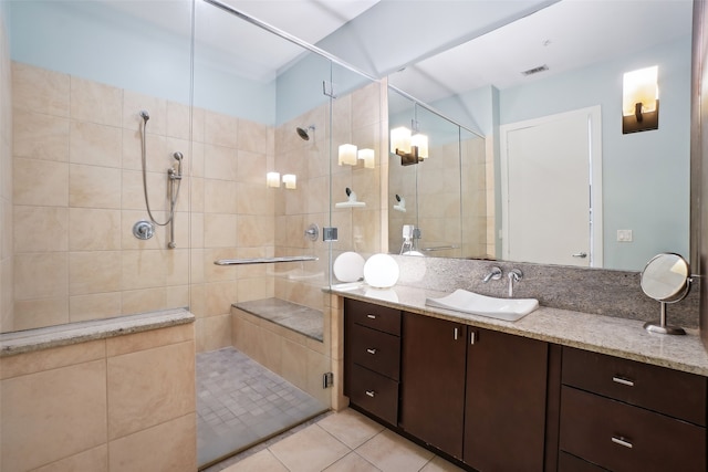 bathroom with tile patterned flooring, vanity, and a shower with door