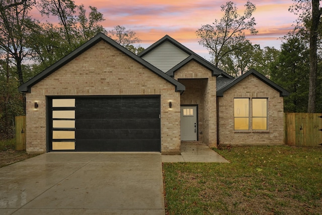 view of front of property featuring a garage and a yard