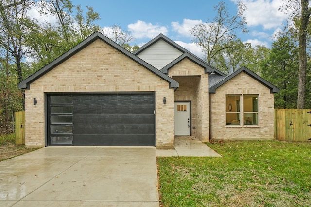 view of front of home featuring a garage and a front lawn