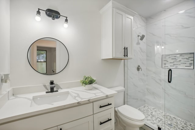 bathroom with vanity, a shower with shower door, a baseboard heating unit, and toilet