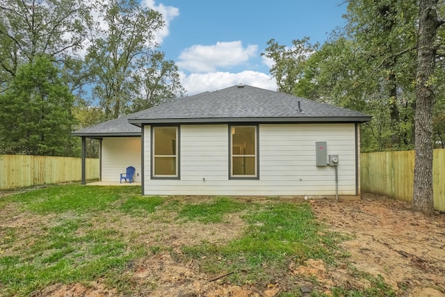 rear view of property featuring a yard