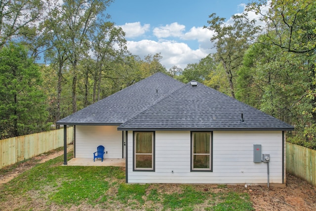 back of house featuring a patio area and a yard