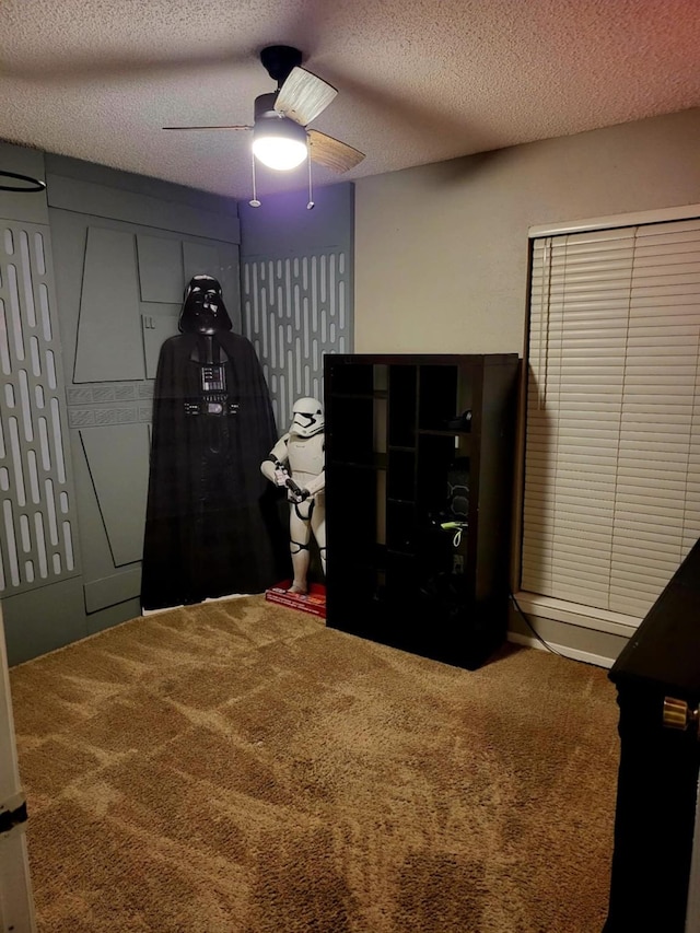 bedroom with carpet flooring, ceiling fan, and a textured ceiling